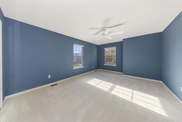 unfurnished room featuring visible vents, ceiling fan, baseboards, and carpet floors