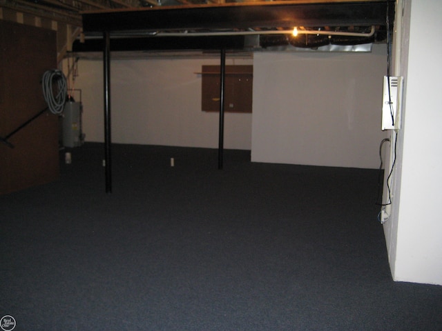 unfinished basement featuring water heater