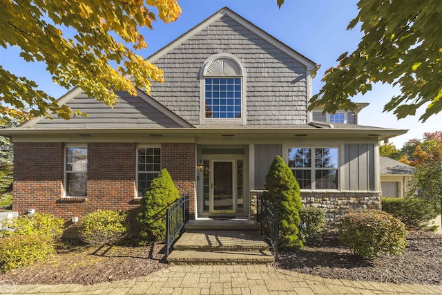 view of front of house featuring brick siding and board and batten siding