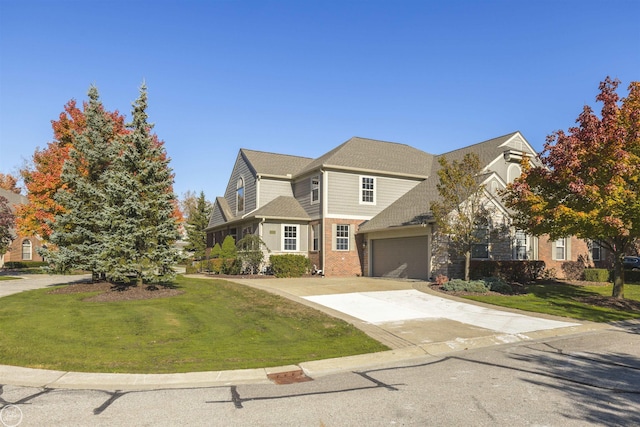 view of front of house featuring a garage, driveway, brick siding, and a front lawn