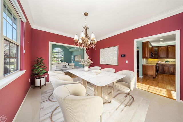 dining area with a notable chandelier, light colored carpet, baseboards, and ornamental molding