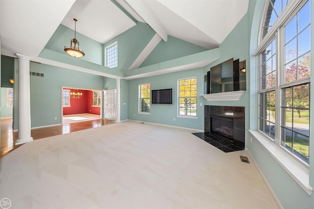 living room with baseboards, visible vents, ornate columns, high vaulted ceiling, and a fireplace