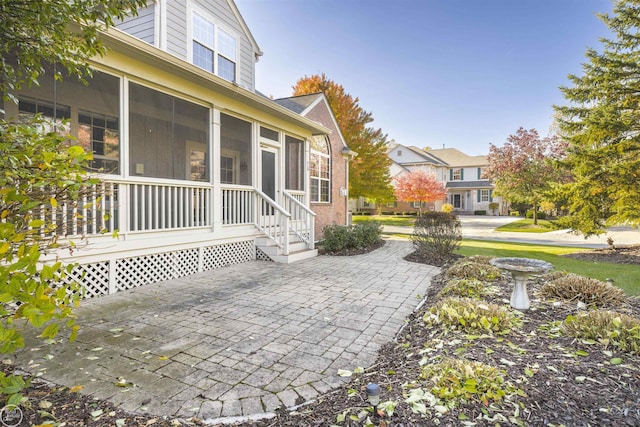 view of patio with a sunroom