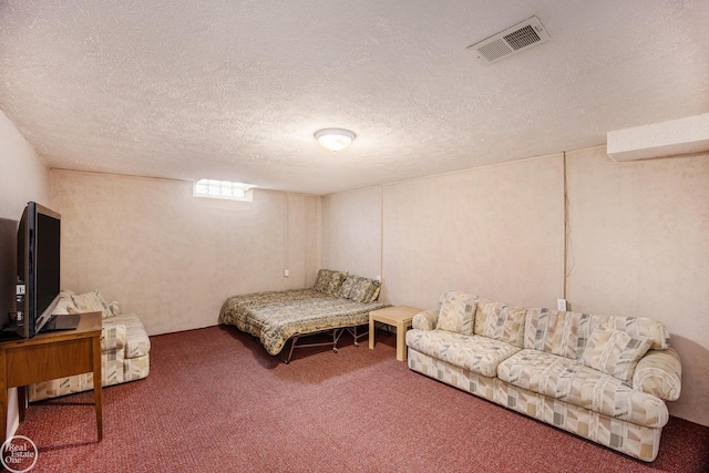 bedroom with carpet, visible vents, and a textured ceiling