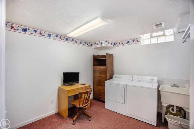 laundry room with a textured ceiling, light colored carpet, laundry area, visible vents, and washing machine and clothes dryer