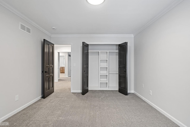 unfurnished bedroom featuring baseboards, visible vents, crown molding, and light colored carpet