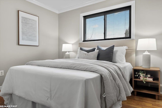 bedroom featuring crown molding and wood finished floors