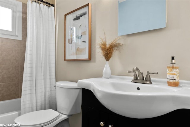 bathroom featuring toilet, shower / tub combo with curtain, and vanity