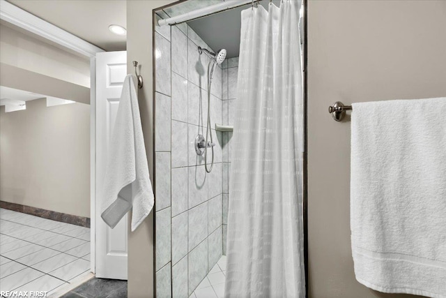 bathroom featuring a shower stall and baseboards