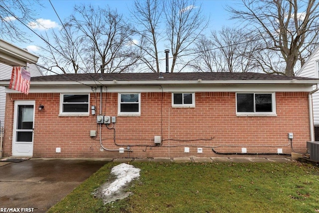 view of side of home featuring crawl space and brick siding