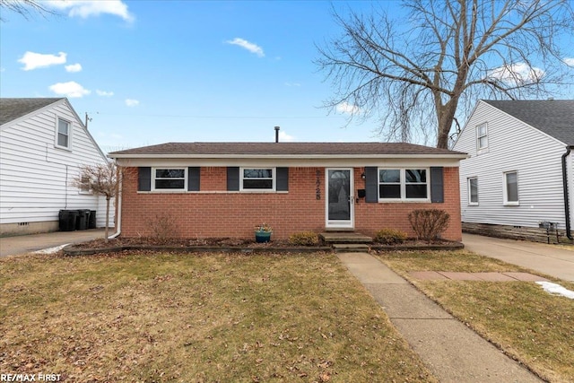 view of front of property featuring entry steps, a front yard, and brick siding