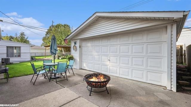 garage featuring fence and central AC unit