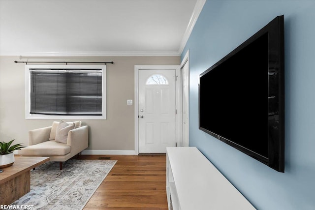 foyer entrance with baseboards, visible vents, ornamental molding, and dark wood finished floors