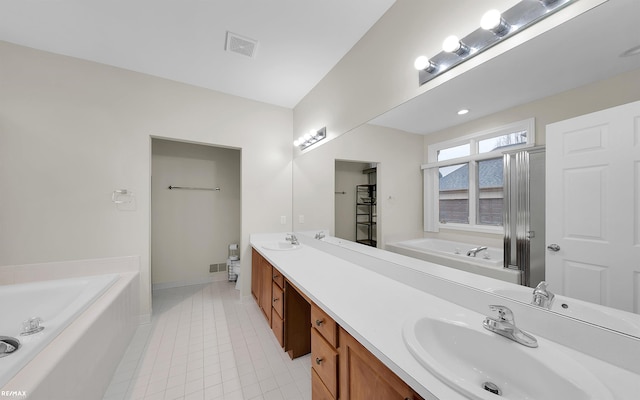 bathroom featuring tile patterned flooring, a sink, visible vents, a bath, and double vanity