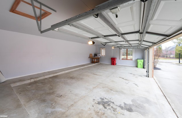 garage with a garage door opener and baseboards