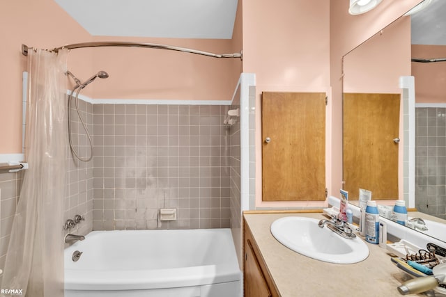 bathroom with shower / tub combo and vanity