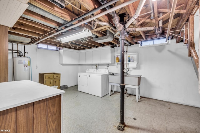 basement featuring light floors, separate washer and dryer, and electric water heater