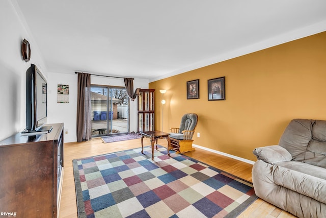 sitting room featuring light wood-style flooring and baseboards