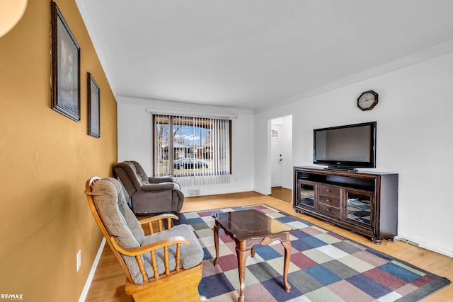 living area featuring wood finished floors and baseboards