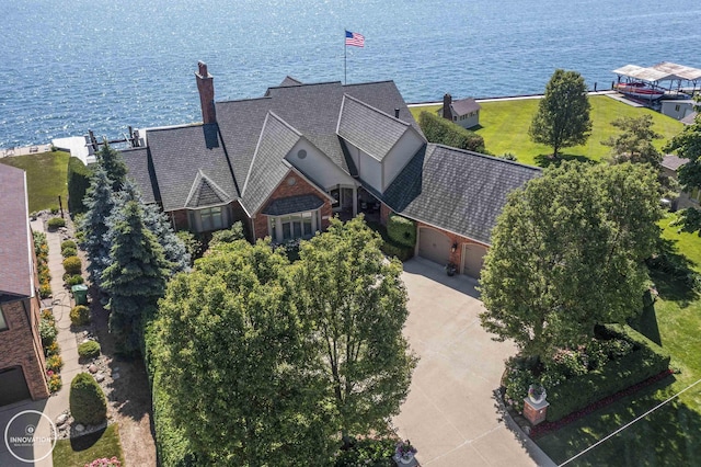 birds eye view of property with a water view