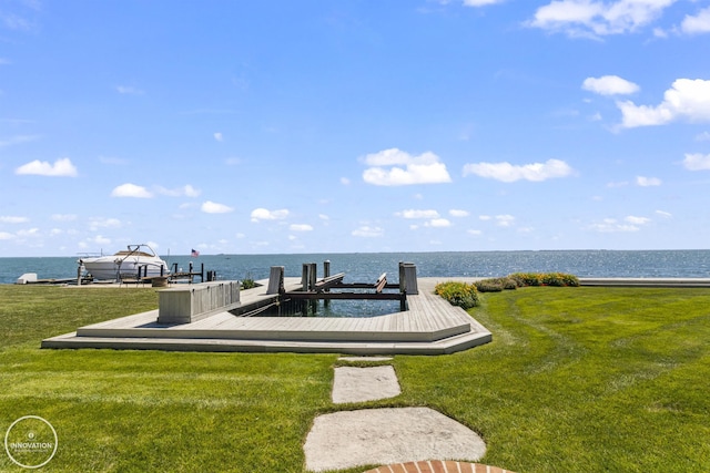 exterior space featuring a lawn and a water view