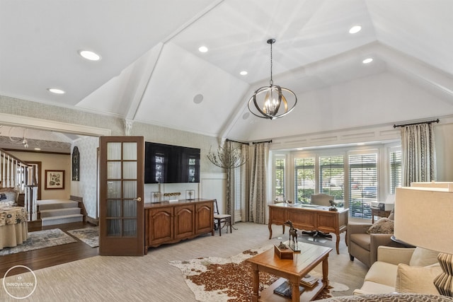 living area featuring wallpapered walls, lofted ceiling, a wainscoted wall, an inviting chandelier, and stairs