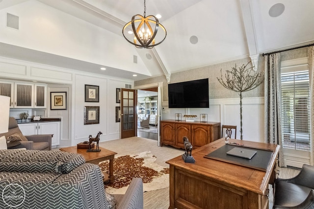 living area featuring a wainscoted wall, visible vents, a decorative wall, an inviting chandelier, and vaulted ceiling