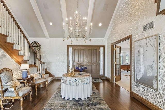 foyer featuring wallpapered walls, stairs, baseboards, and dark wood-type flooring