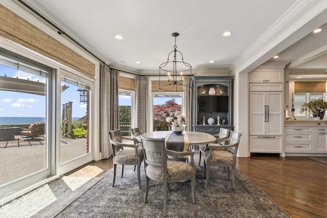 dining space with ornamental molding, a chandelier, dark wood-type flooring, and recessed lighting