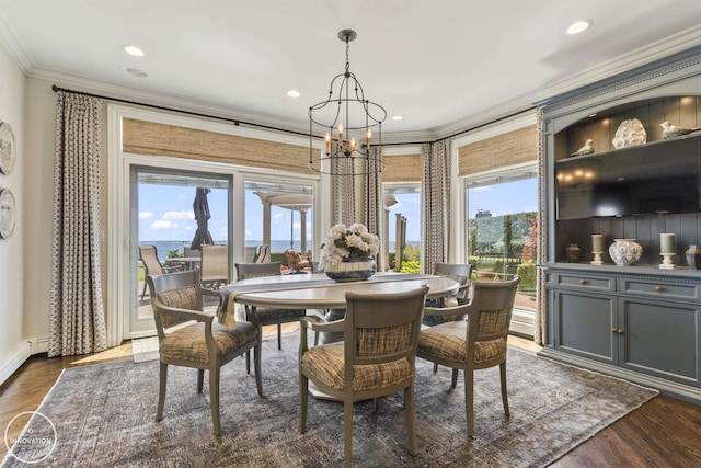 dining room with a chandelier, ornamental molding, dark wood-type flooring, and recessed lighting