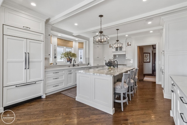 kitchen featuring dark wood-type flooring, white cabinets, and decorative backsplash