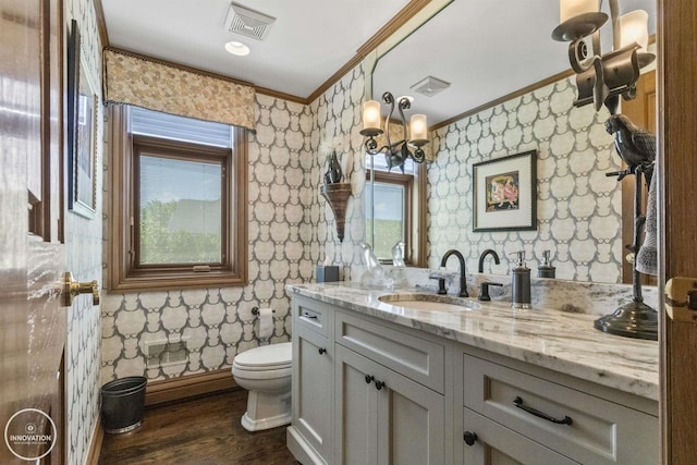 bathroom featuring visible vents, toilet, ornamental molding, wood finished floors, and wallpapered walls