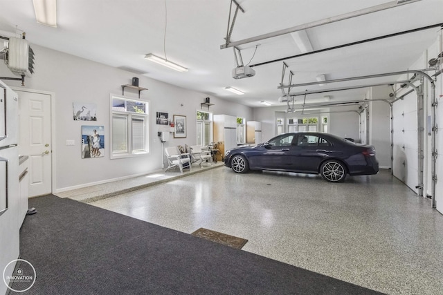 garage featuring baseboards and a garage door opener