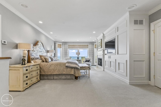 bedroom with recessed lighting, light colored carpet, visible vents, a glass covered fireplace, and crown molding