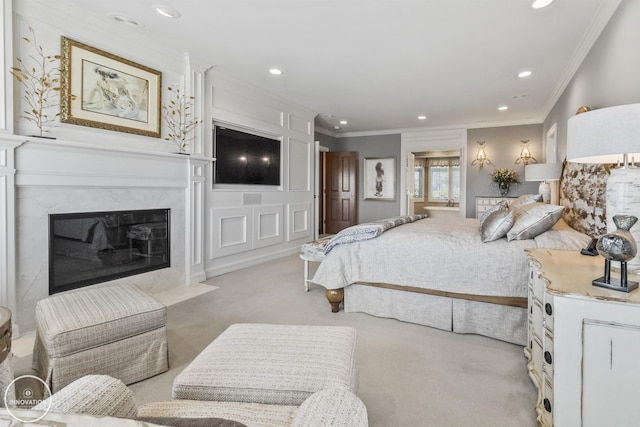 bedroom with recessed lighting, a fireplace, ornamental molding, and light colored carpet