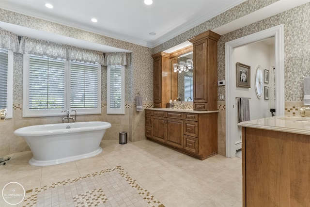 full bath featuring crown molding, a freestanding bath, vanity, and wallpapered walls