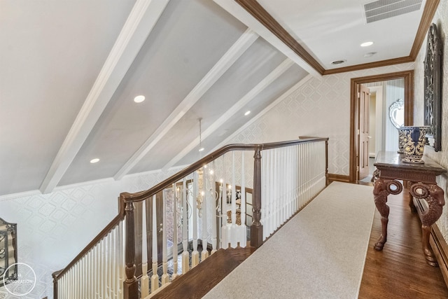 hallway featuring wallpapered walls, visible vents, beamed ceiling, wood finished floors, and crown molding