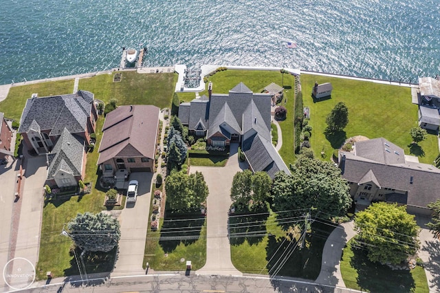 drone / aerial view featuring a residential view and a water view