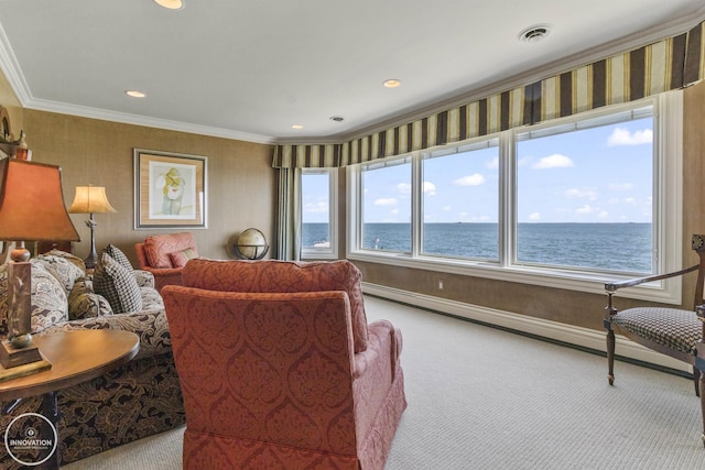 carpeted living area with wallpapered walls, a water view, visible vents, and crown molding