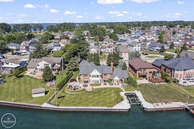 birds eye view of property with a residential view and a water view