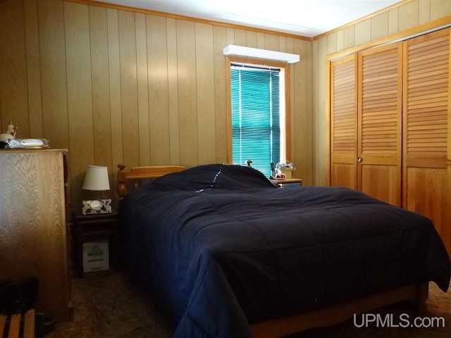 bedroom featuring ornamental molding, a closet, and wooden walls