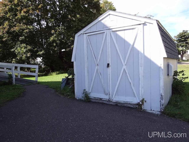 view of shed with fence