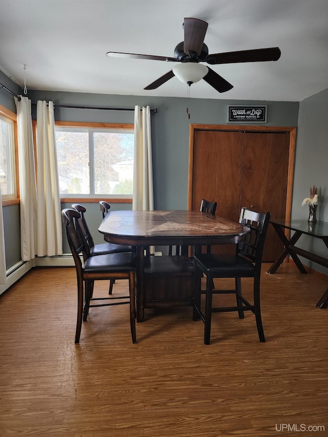 dining space with wood finished floors