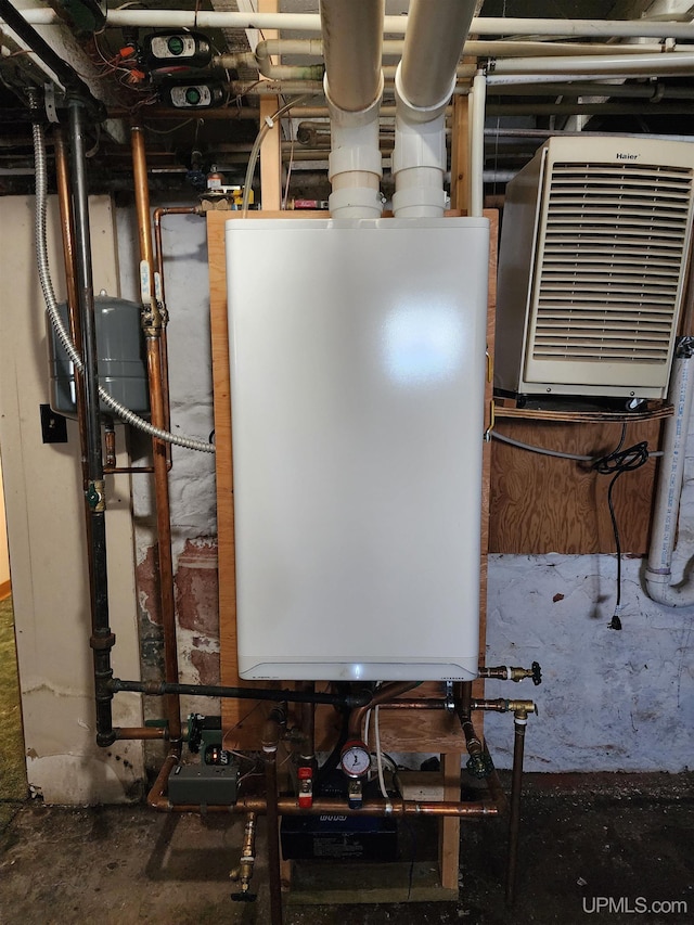 utility room featuring water heater