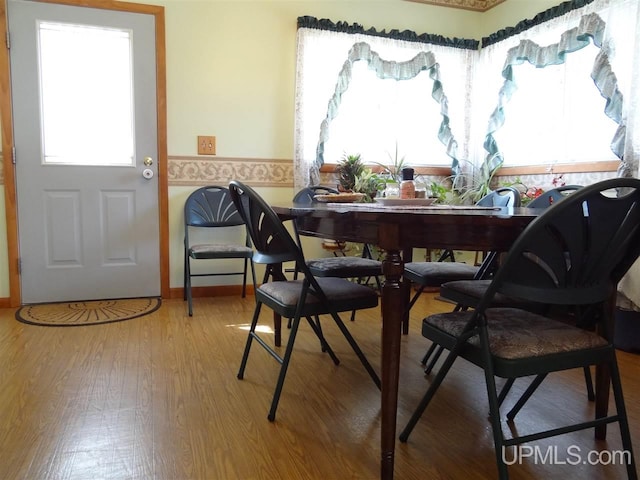 dining space with wood finished floors