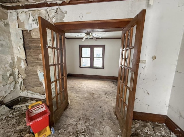 interior space with baseboards, ornamental molding, ceiling fan, and french doors