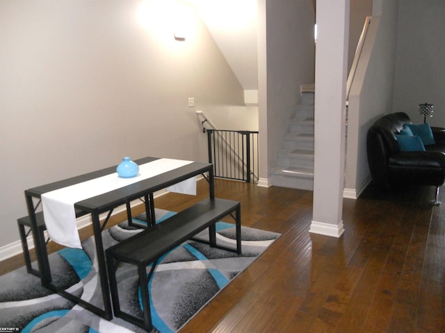 dining room featuring hardwood / wood-style flooring and baseboards