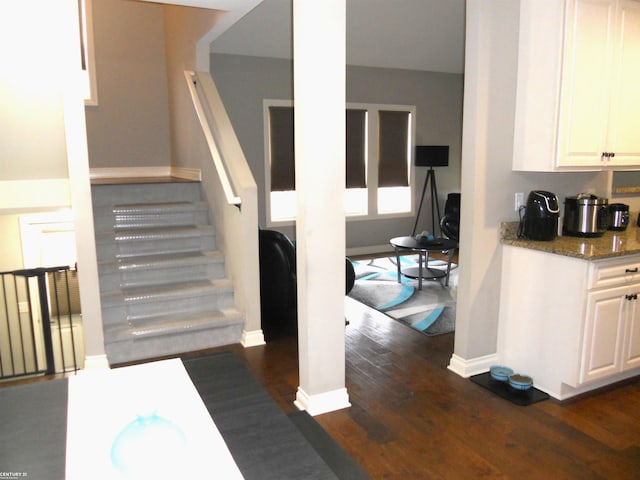 stairway featuring wood finished floors and baseboards