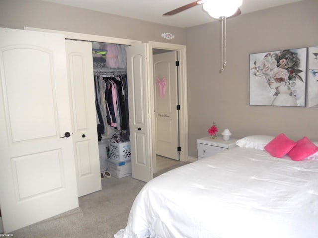 bedroom featuring light carpet, ceiling fan, and a closet