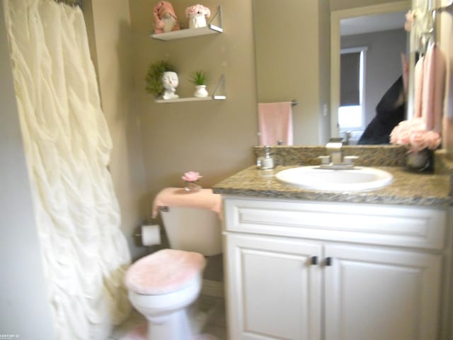 full bathroom featuring toilet and vanity